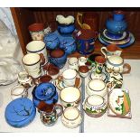 A large collection of Torquay Pottery wares, including a Watcombe beaker "Town & Hamlets,
