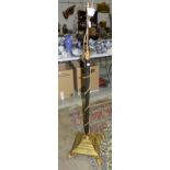 A Regency-style gilt metal adjustable electrified oil lamp stand on paw feet.