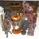 A collection of Oriental and other carved wood figures, a wooden hour glass, a hunting crop and