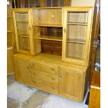 An Ercol Windsor-style elm sideboard/display cabinet, having a twin-glazed door bookcase top with