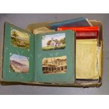 A collection of approximately 50 postcards in an album and a quantity of mixed loose postage stamps.