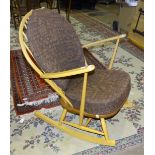 An Ercol elm rocking chair with loose seat and back cushions.