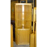 An Ercol Windsor-style freestanding elm corner cupboard with open shelves over a cupboard door, 76cm