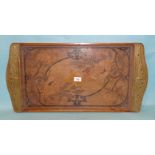 An Art Nouveau poker-work wooden tray signed RM.09, the handles overlaid with brass jewelled