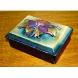 A Moorcroft Pottery rectangular box and cover with floral decoration, impressed signature and
