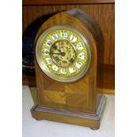 A mahogany dome-shaped striking mantel clock with pierced gilt metal dial, the movement stamped