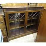 A mahogany bookcase, the rectangular top above a pair of astragal-glazed doors, on plinth base,