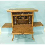 A Victorian lacquered bamboo gaming table, the swivel top above drop-down panels revealing a