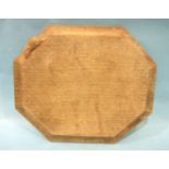 A Robert (Mouseman) Thompson of Kilburn workshop oak bread board of octagonal shape, carved with