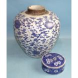 A large Chinese porcelain jar decorated with blue flowering lilies on a leafy black ground,