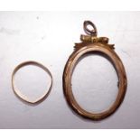 A 22ct gold wedding band, (sawn through), 2g and a 9ct gold locket frame, (a/f), 3.4g, (2).