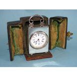 An Edwardian silver-cased dressing table clock, the plain rectangular case with C-scroll handle,