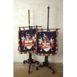 A pair of mid-19th century rosewood pole-screens with fine illuminated armorial silk panels.