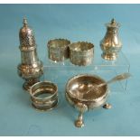 A Victorian silver circular salt with shell and hoof feet, a castor with pierced top, three napkin