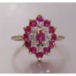 A 9ct yellow and white gold ruby and diamond cluster ring set twelve round-cut rubies and eight
