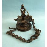An antique bronze hanging temple oil lamp, with seven wick wells, suspended from a chain, 15cm, 56cm