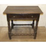 An antique oak rectangular side-table, the top above a frieze drawer on ring-turned legs and