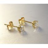 A pair of diamond ear studs in 18ct yellow gold mounts, total diamond weight 0.5cts approximately,