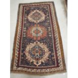 An early to mid-20th century oriental rug, the central design including stylised animals on blue and