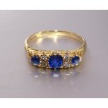 A Victorian sapphire and diamond ring set three round-cut sapphires and two pairs of old brilliant-