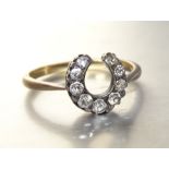 A Victorian diamond horseshoe ring, claw-set nine graduated old brilliant-cut diamonds in silver