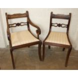 A set of eight Regency sabre-legged mahogany dining chairs, each with reeded frame, centre bar and