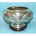 A Chinese silver rose bowl of squat form, with raised decoration of a dragon, character marks and