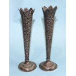 A pair of Asian silver spill vases embossed with foliate decoration, 15.5cm high, (2).