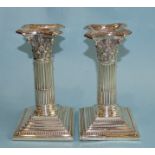 A pair of silver short loaded Corinthian column candlesticks, Birmingham 1897, 16cm high.