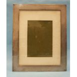 A rectangular engine-turned silver photograph frame, maker E Mander Ltd, Birmingham 1924.