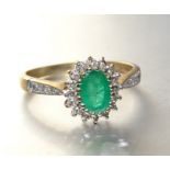 An emerald and diamond oval cluster ring with 9ct gold mount, size R, 2.6g.