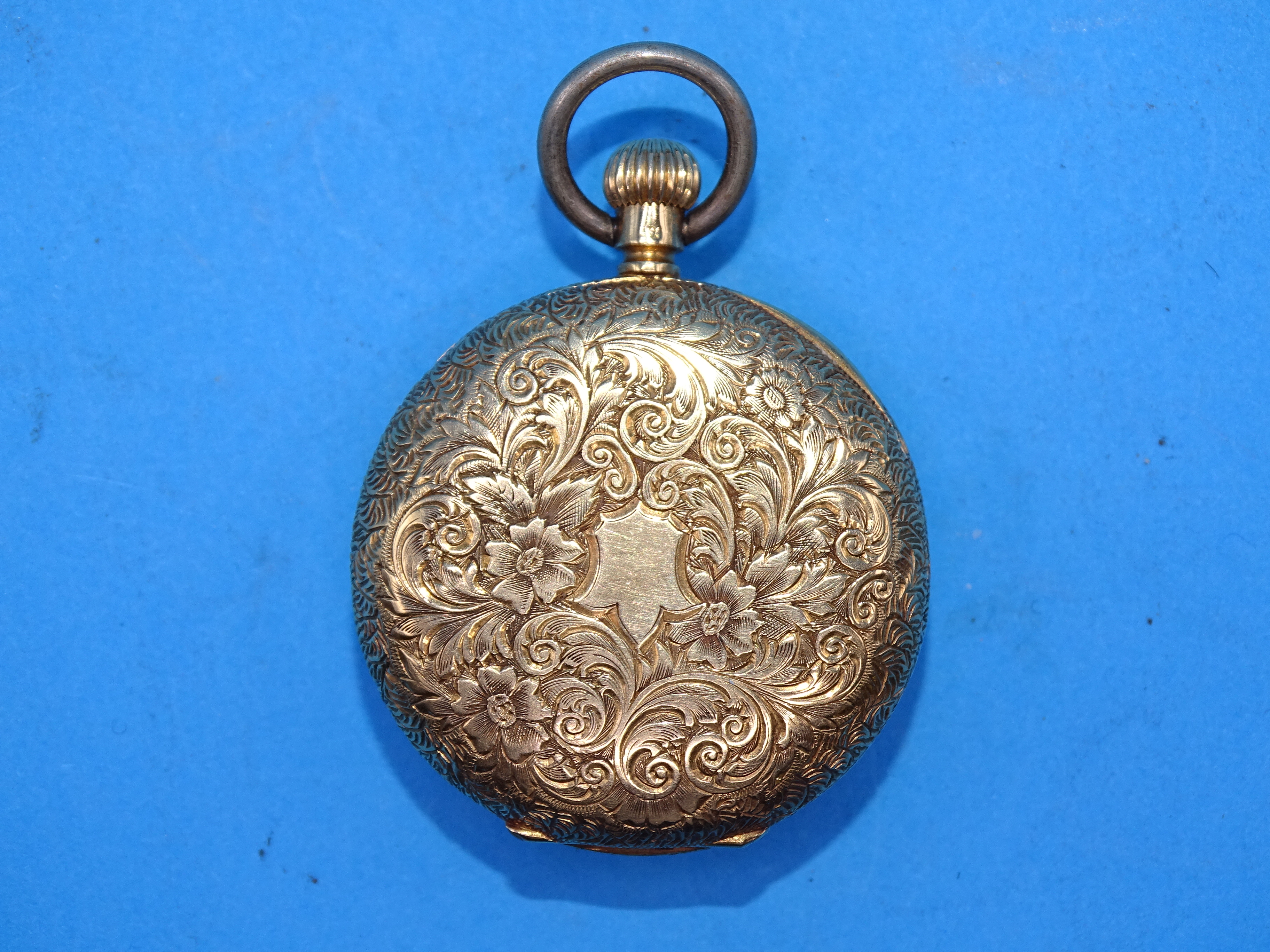 A ladies 18ct gold-cased open-face pocket watch, the engraved gilt dial within floral-engraved case, - Bild 2 aus 3