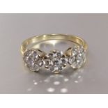 A diamond triple cluster ring, each cluster set seven brilliant-cut diamonds, total diamond weight