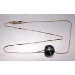An 18ct yellow gold fine box-link neck chain with a large black cultured pearl, possibly South