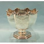 A good-quality silver octagonal rose bowl with cast and shaped scroll border supported by an