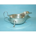 A plain silver sauce boat with C-scroll handle, on three short legs, Sheffield 1960, ___3.5oz.