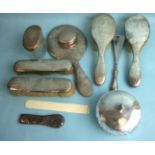 A collection of silver dressing table items, mirror, brushes, trinket pot, a cut-glass silver-