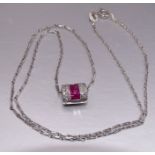 A ruby and diamond pendant of oval cylinder form, channel-set ten square cut rubies between pavé-set