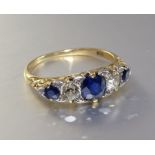 A Victorian sapphire and diamond five-stone ring set three round-cut sapphires and two old