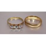 A 9ct gold wedding band, size M, 3.8g and a 9ct gold ring set three C-Z stones, size N, 1.6g, (2).