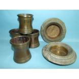 A pair of plated metal anklets with later inset dishes, 15cm diameter and four bronze beakers of