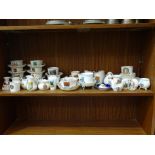 A collection of approximately fifty pieces of W H Goss crested ware including cups and saucers,