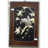 An Oriental rectangular mother of pearl and ivory decorated wall plaque depicting a bird of prey