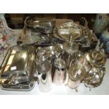 A collection of plated ware comprising entrée dishes, cocktail shaker, tea service trays,