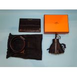 A Hermes leather key ring tassel, boxed, a Saint Laurent crocodile-effect credit card holder and a
