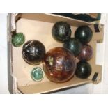 A collection of nine glass floats various sizes.