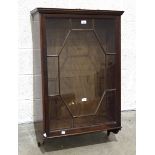 An Edwardian walnut display cabinet, the dentil cornice above a rectangular astragal glazed door,