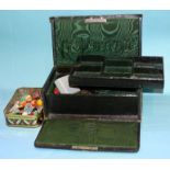 A good quality Edwardian jewellery case of dark green Morocco leather with moire silk and velvet