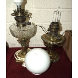 A brass oil lamp in the form of a short Corinthian column candlestick, with cut-glass reservoir