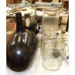 A large amber glass shaped carboy, a liquid paraffin pharmaceutical bottle with pourer, other